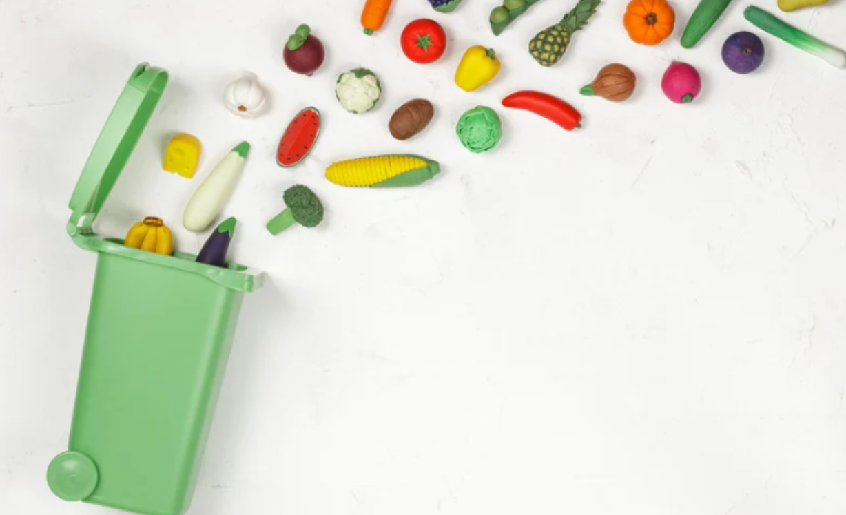 Mindful Living. Sustainable Living. Homemade baby food. Reduce Waste. Eco-Friendly Baby Food. Sustainable Baby Feeding. Healthy Baby Food at Home. Waste bin with whole foods spilling up out of it.