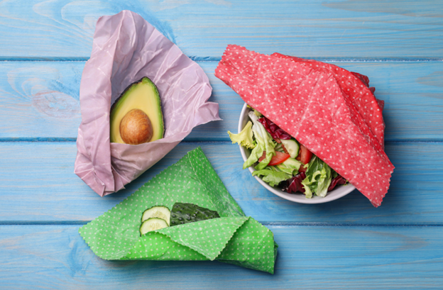 Sustainable Swaps. Eco-Friendly Swaps. Easy Sustainable Swaps. Easy Swaps. Avocado, salad bowl and cucumber being covered with beeswax food covers.