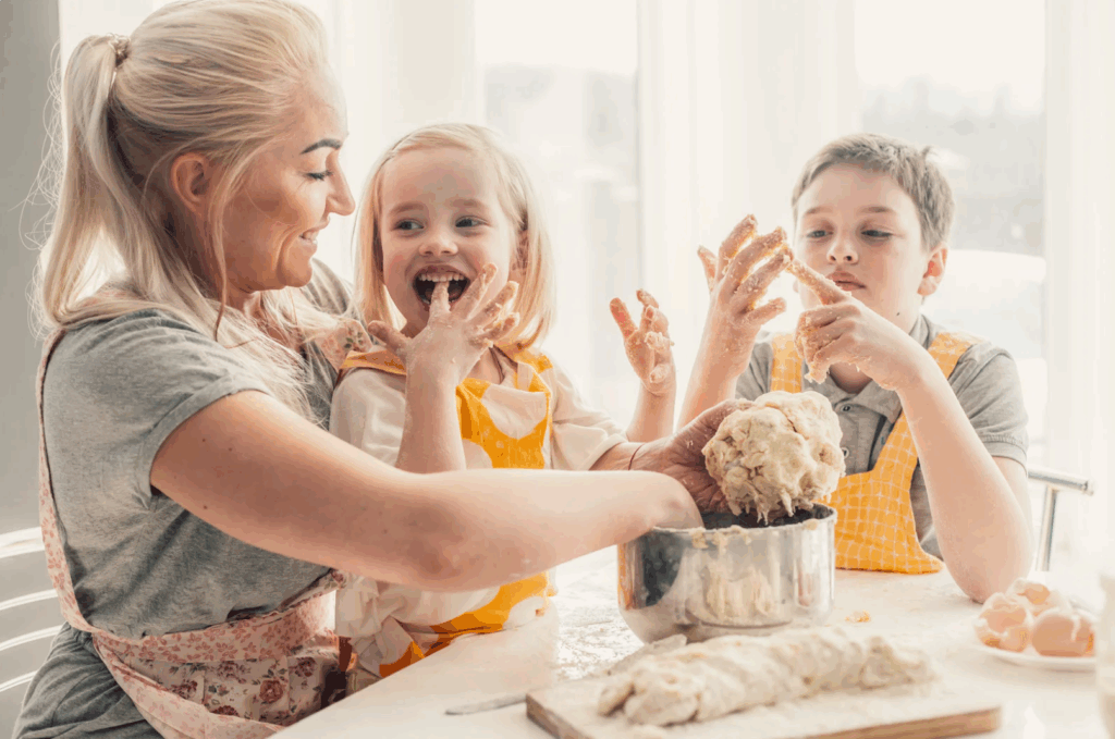 A mom is cooking with her 2 children image.