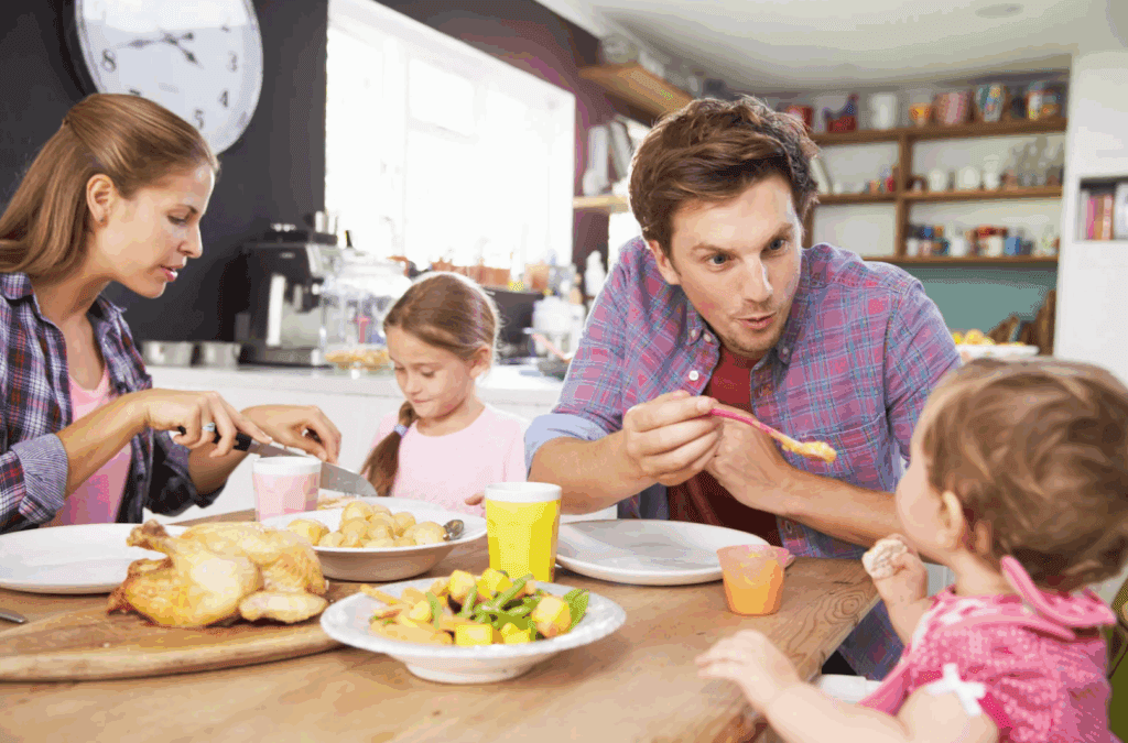 A family of 4 sitting together at the table, enjoying a mindful meal.