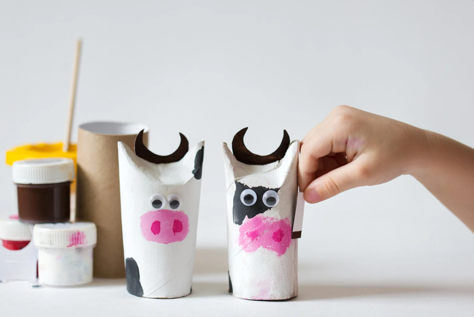 A recycled activity using old toilet paper roll and googly eyes and paint to make cows.